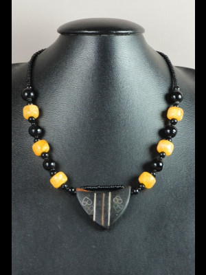 Necklace with wood pendant, glass beads and beads imitating amber