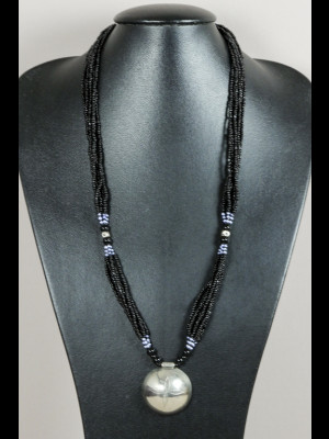 Necklace with glass beads and a silvered metal pendant