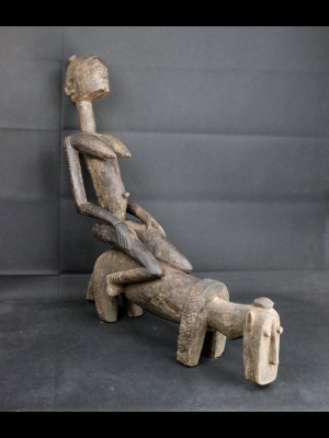 Character sitting on the back of a dog (Dogon-Mali)